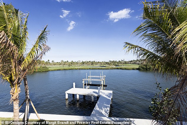 A private dock juts out into the calm waters of Lake Worth Lagoon, saving future owners the hassle of finding a place to store their boats.