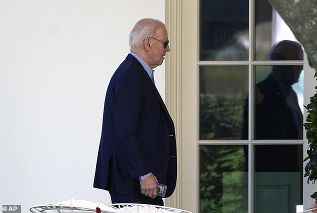 Biden is seen here walking to the Oval Office after returning from Delaware to consult with his national security team.