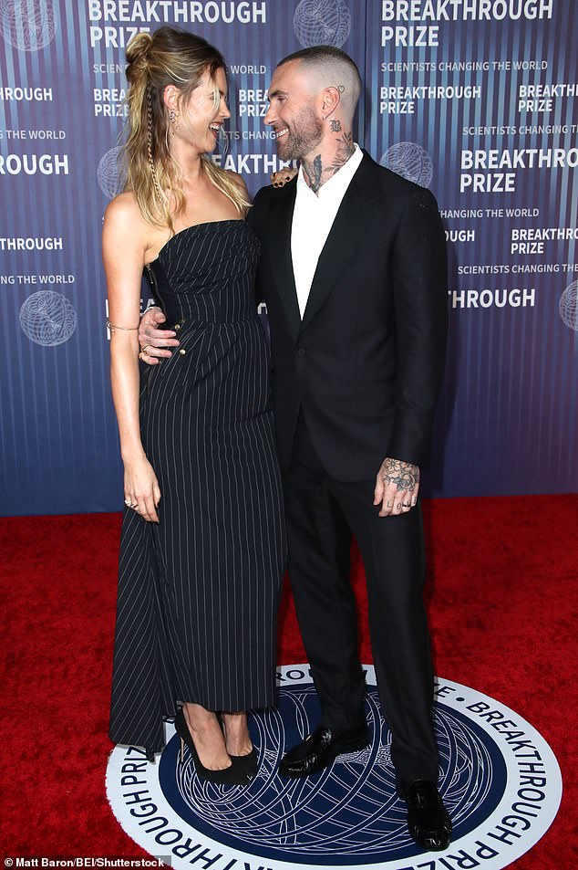 While posing on the red carpet before the event celebrating scientific achievements, the supermodel and the Maroon 5 frontman were seen laughing and smiling as they looked into each other's eyes.