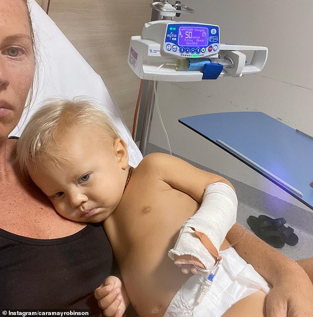 A scan in March found cancer cells in 84 per cent of Max's body, after a scan just a month earlier found none (pictured, Max and Mrs Robinson in hospital).