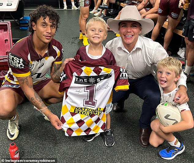 Clara Robinson explained that Max (pictured meeting the Broncos with his brother) needs treatment to target the mutated cancer cells, which is not available in Australia.