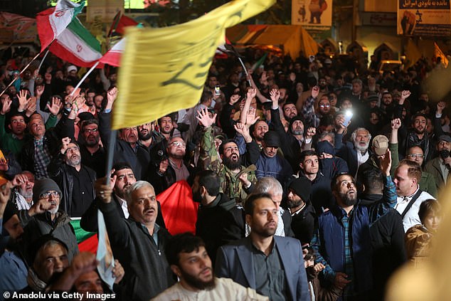 People with Iranian flags gather to hold a demonstration in support of Iran's attack on Israel in Tehran.
