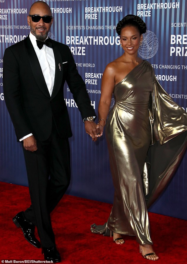Alicia Keys, resplendent in a sparkling gold dress that fell off one side of the fashionable shoulder, walked the red carpet hand in hand with her husband Swizz Beatz.