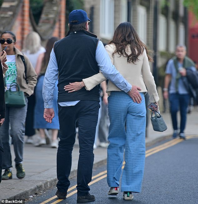 Martin, 51, looked relaxed in a blue vest and matching jeans as he walked arm in arm with his new girlfriend, Arun Nayar's ex-wife.