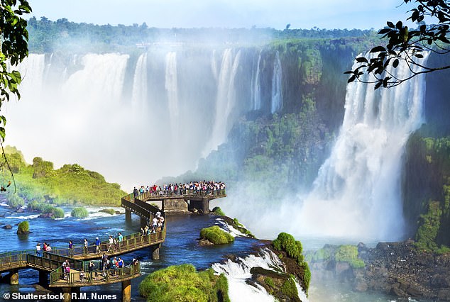 Tourists at Iguazu Falls, one of the great natural wonders of the world, on the border of Brazil and Argentina
