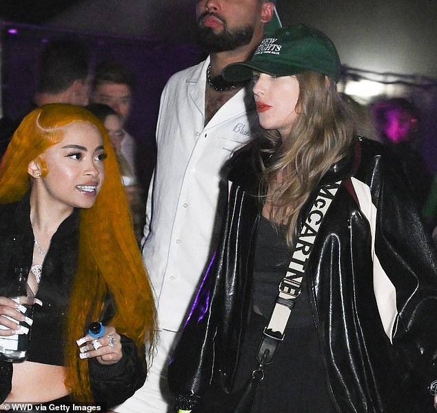 Swift photographed with her friend and rapper Ice Spice wearing her New Heights cap