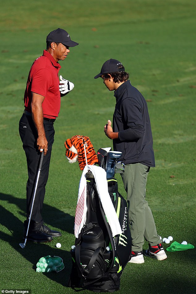 Tiger Woods is seen warming up on the driving range with his son, Charlie.