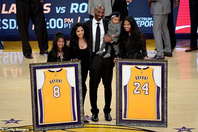 Kobe Bryant poses with his family at halftime of a Lakers game in December 2017.