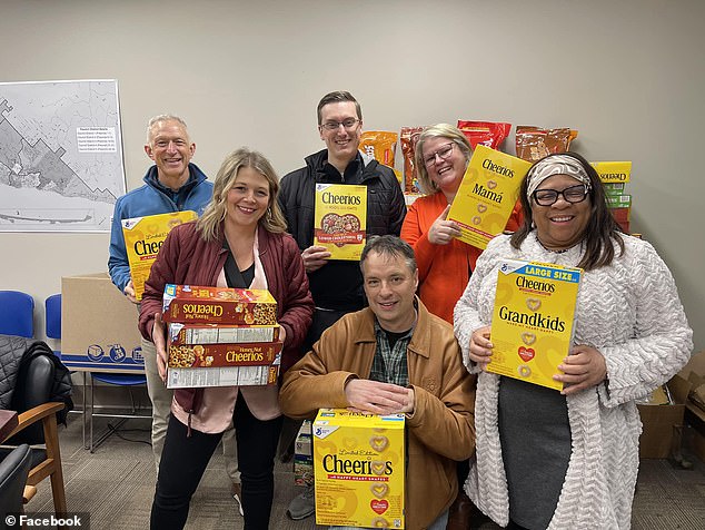 In response to his comments, locals donated hundreds of boxes of cereal to a city food drive. Reinert (far left, back) was photographed with a box of Cheerios at the drop-off location.