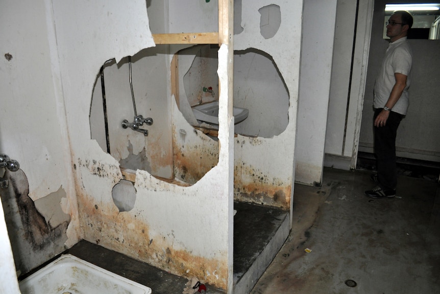 Three bathrooms with large holes in the center. 