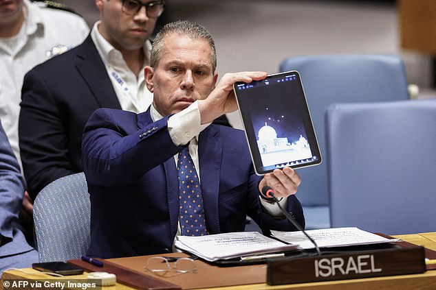 Israel's ambassador to the UN, Gilad Erdan, shows a video during a meeting of the United Nations Security Council on the situation in the Middle East