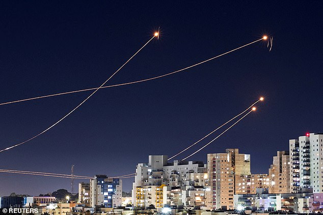 Pictured: An anti-missile system in Israel intercepting rockets launched earlier this year from the Gaza Strip.