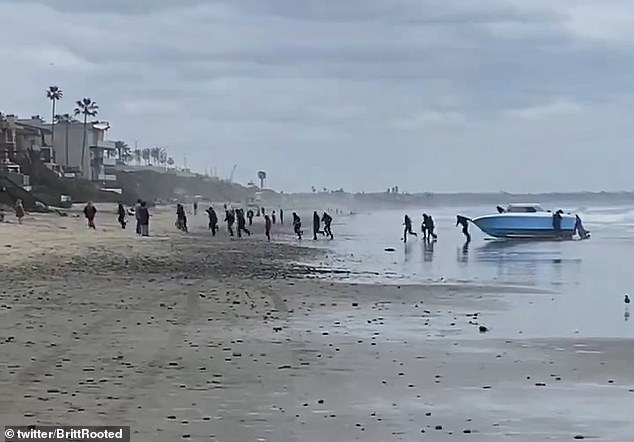 After beaching the boat on the sand, the migrants got out and ran toward the row of waterfront houses on Saturday.