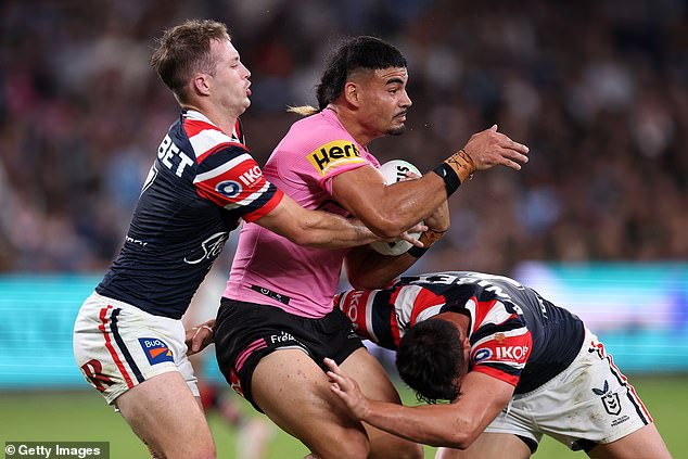 May (pictured center playing against the Roosters in round four) also made headlines for her extreme neck tattoo last week.