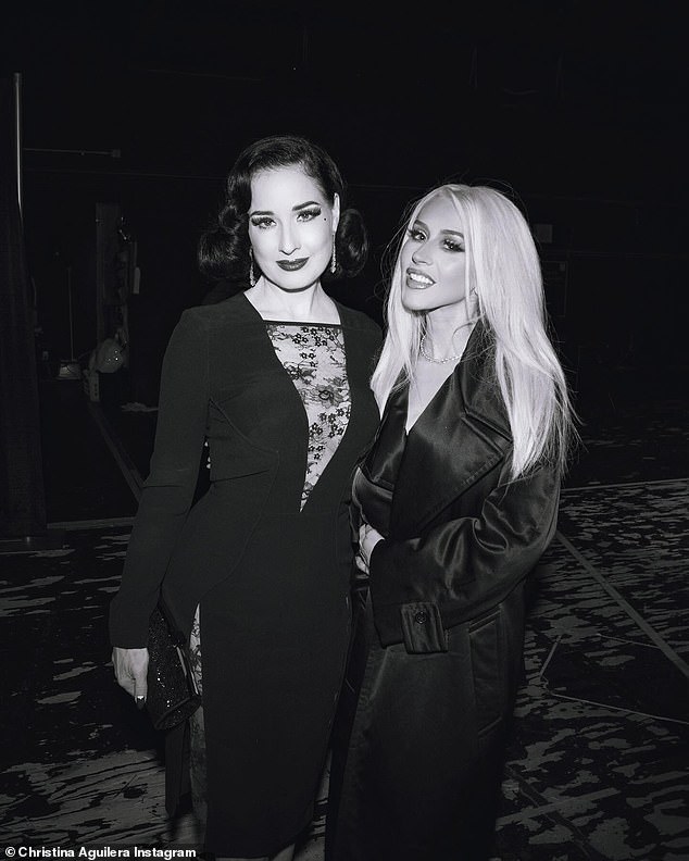 The next image showed Aguilera posing with another famous friend, Dita Von Teese, dressed in an elegant black dress.