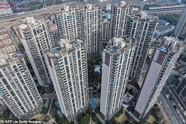 But Dr Chalmers said China's growth rate would likely be a '4' ahead for three consecutive years, marking the slowest expansion since it opened to world trade in 1978 (pictured, towers of Evergrande apartments in Nanjing, eastern China). )