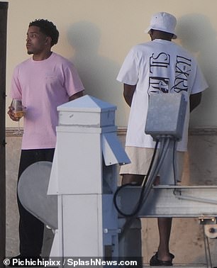 Justin kept it casual in a pink T-shirt and black pants while Diddy relaxed in a bucket hat and sandals.