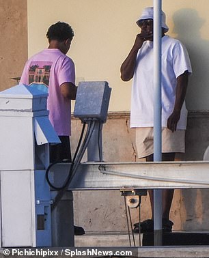 Diddy relaxed in a bucket hat and sandals.