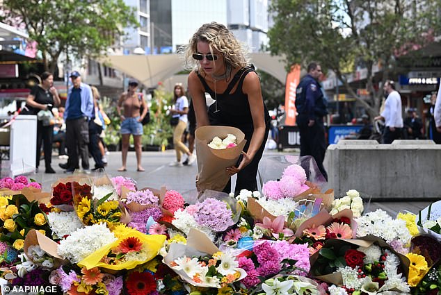 Members of the public are seen paying their respects to the victims of the Bondi Junction stabbing.