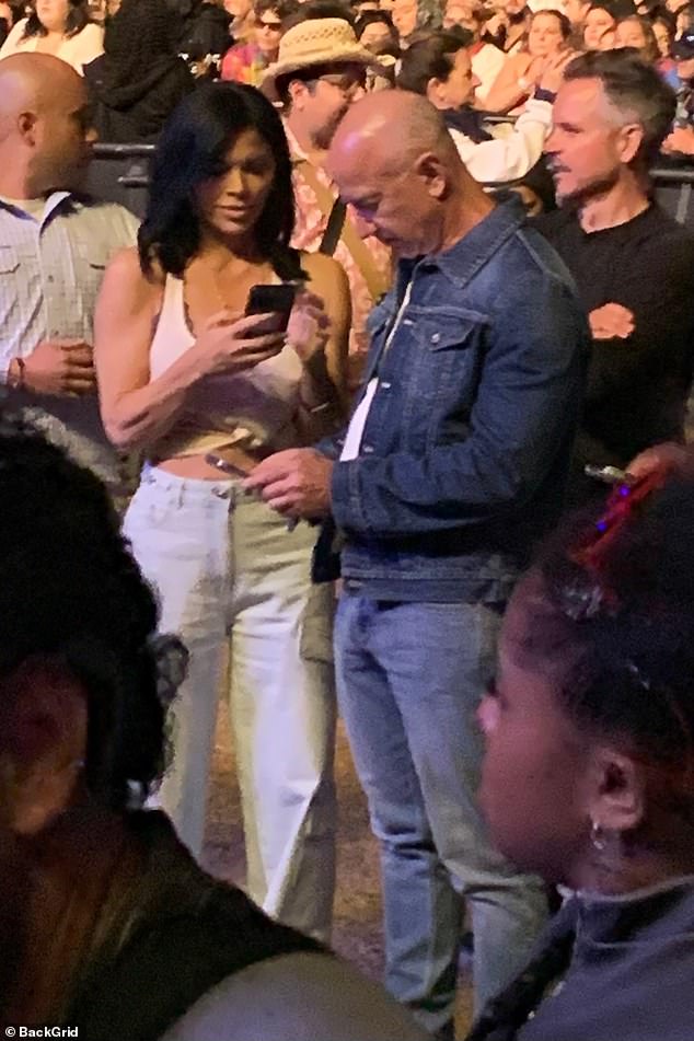 Eff Bezos was seen alongside his fiancee Lauren Sanchez as the couple appeared to be engrossed in their phones while at the Coachella music festival this weekend.