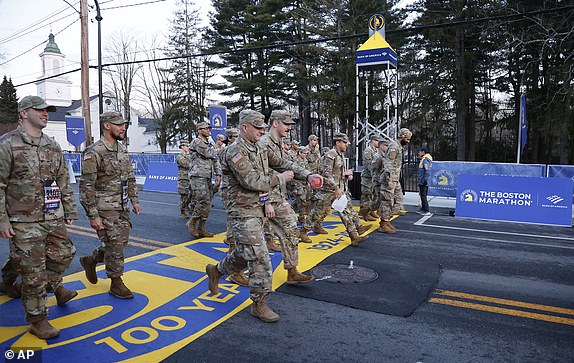 Members of the U.S. military cross the starting line while participating in the Boston Marathon, Monday, April 15, 2024, in Hopkinton, Massachusetts (AP Photo/Mary Schwalm)