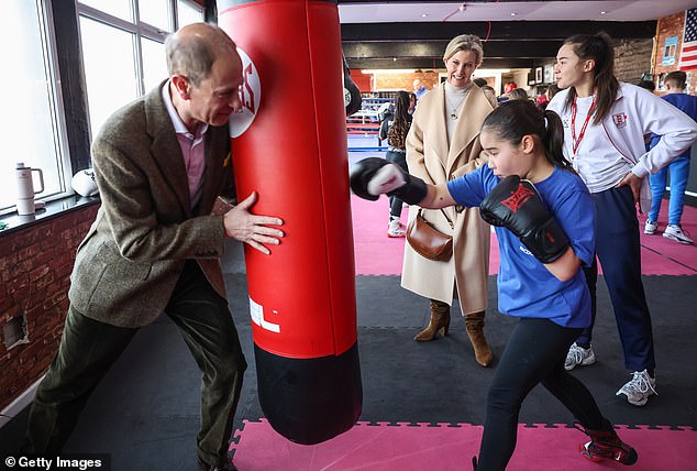 The Duke of Edinburgh (pictured left) holds the heavy punching bag for 11-year-old Lacey Douglas (pictured right) against junior national champion Amy Nolan at the Right Stuff Amateur Boxing Club.