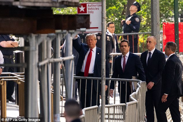 Trump enters the Criminal Courthouse in midtown Manhattan with attorneys Todd Blanche and Emil Bove and greets the gathered crowd.