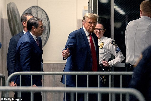 Former US President Donald Trump returns from a break as jury selection begins in his trial at Manhattan Criminal Court on April 15, 2024 in New York City.