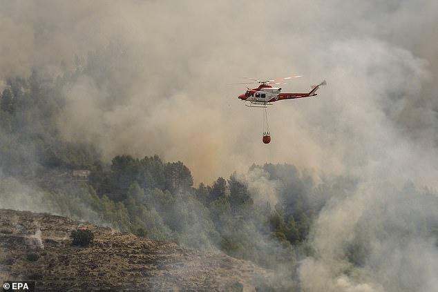 A Spanish firefighting helicopter is seen during a forest fire that broke out in the town of Tárbena, Alicante, eastern Spain, April 15, 2024.