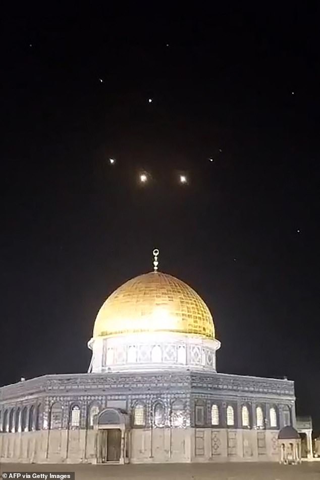 An image capture from a video taken early on April 14, 2024 shows rocket trails in the sky over the Al-Aqsa Mosque complex in Jerusalem.