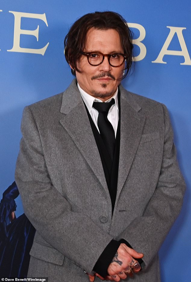 The actor, who is trying to make a comeback with his first film in four years, wore a long gray coat with a black suit underneath for the premiere.