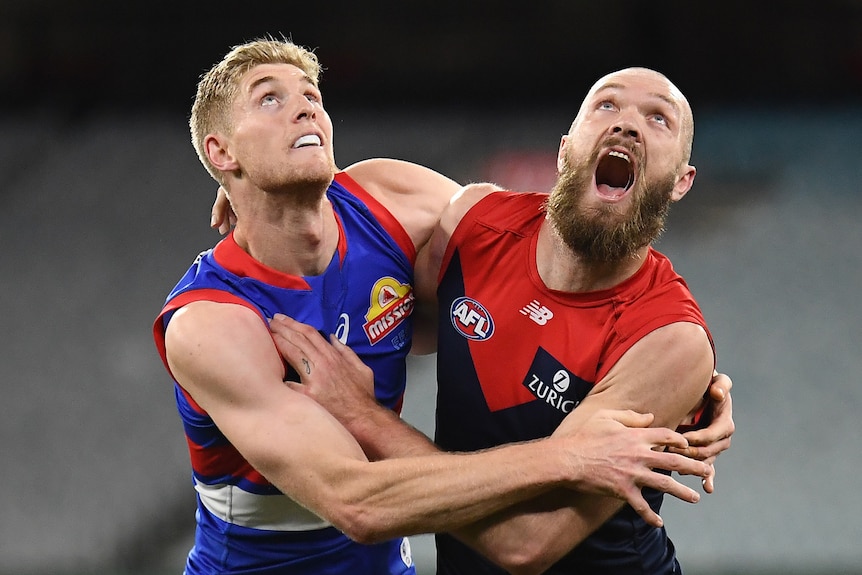 Two AFL players fighting for the ball during a match 