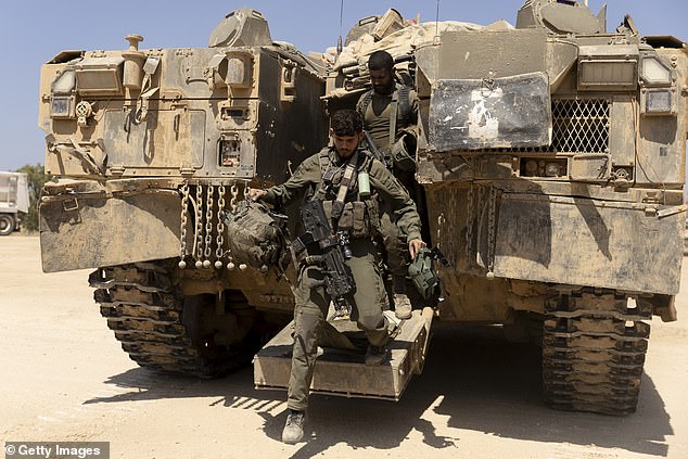 Israeli soldiers exit an armored personnel carrier near the border with the Gaza Strip on April 15.