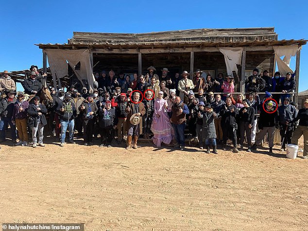 Alec Baldwin, Halyna Hutchins, and gunsmith Hannah Gutierrez-Reed appear in this Rust cast and crew photo.