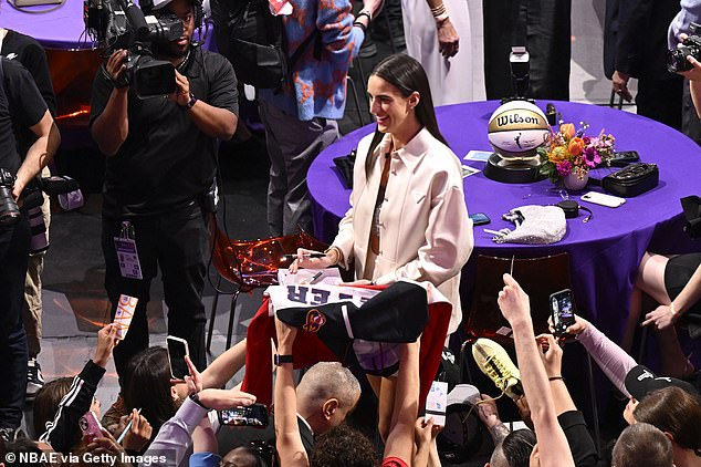 Caitlin Clark signs autographs for fans during the 2024 WNBA Draft on April 15