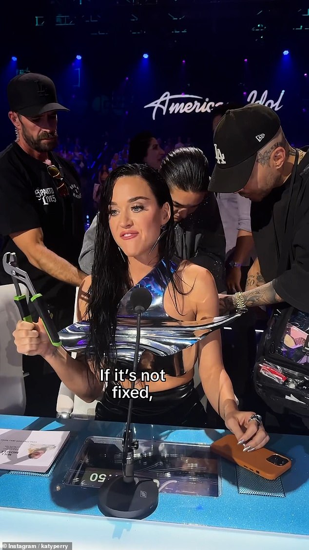 A behind-the-scenes video shared on Instagram showed wardrobe assistants frantically trying to fix the piece as Katy told the camera: 