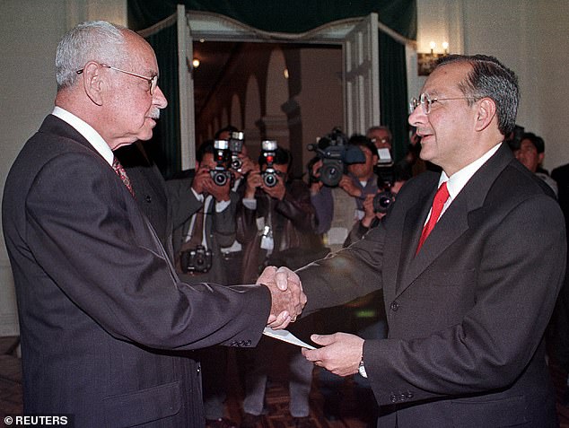 Bolivian President Hugo Banzer shakes hands with Rocha, the new U.S. ambassador to Bolivia, during a ceremony at the Government Palace in La Paz, August 3, 2000.