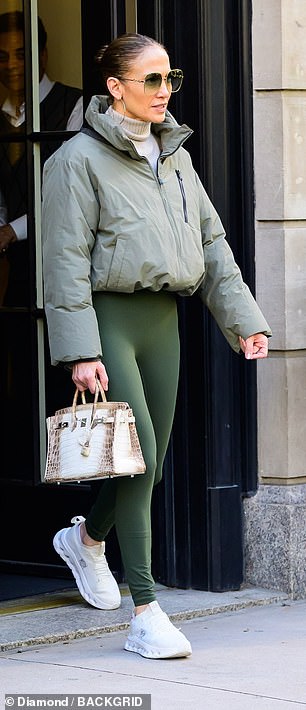 The fashion-forward Hollywood figure created a monochromatic look by adding a cropped pale green puffer jacket.