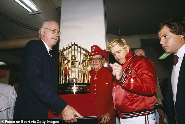 MLB's Bowie Kuhn presents Cardinals owner August Busch and Herzog with the World Series trophy