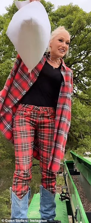 He wore a long red and black plaid shirt with rolled up sleeves over matching plaid pants and a black t-shirt.  The fashionista wore knee-high boots covered in light denim and