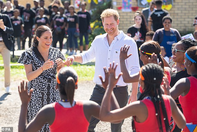 She claimed she stayed in her role three times longer than she had originally planned because officials struggled to find a replacement for her.  When she found herself a new private secretary, they resigned during Harry and Meghan's tour of Africa in 2019, Cohen claimed.  Above: Harry and Meghan meet a group of dancers in Nyanga Township in Cape Town, South Africa.
