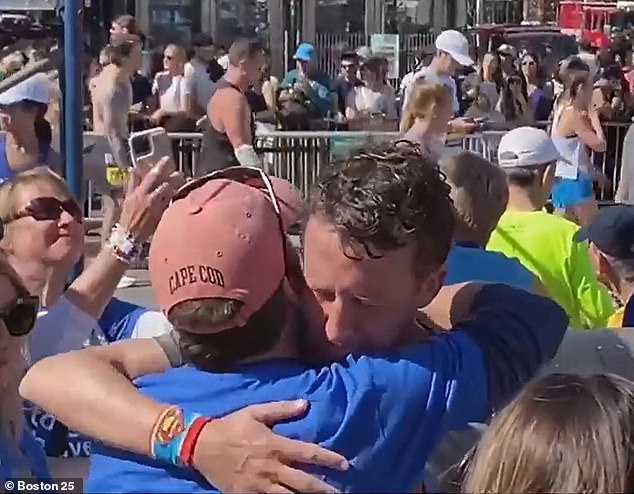 The marathon was a form of therapy for the devastated father (pictured hugging a friend at the finish line on Tuesday). Her partner, depressed midwife Lindsay Clancy, allegedly murdered her three children in January 2023.