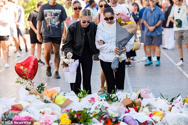 Six innocent shoppers, including five women and one man, were fatally stabbed at Westfield Bondi Junction (pictured, floral tributes from the public outside Westfield Bondi Junction)