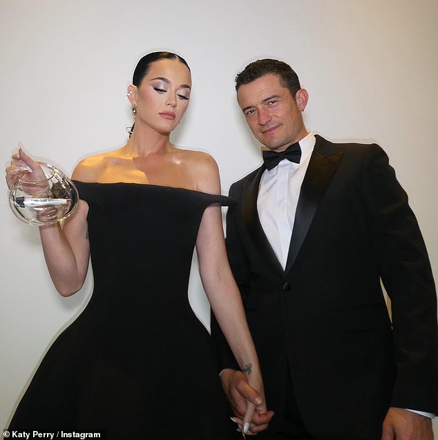 Perry has been subtly hinting that new music could be on the horizon.  As she and her fiancé Orlando Bloom headed to the Breakthrough Awards on Saturday, she carried a clear purse with a scroll titled KP6: Top Secret in a clear glass tube.