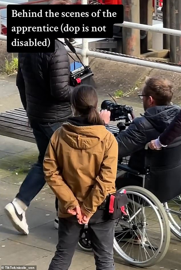 A cameraman was sitting in a wheelchair while another crew member dragged him.