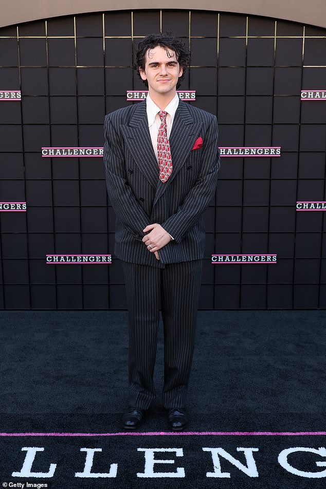 Jack Dylan Grazer, 20, famous for his role in the horror film IT, looked dapper in a pinstripe suit and red tie.