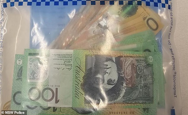 Police found $13,000 (pictured) in a nearby fire extinguisher cabinet and a mobile phone in another, which were seized for forensic testing.