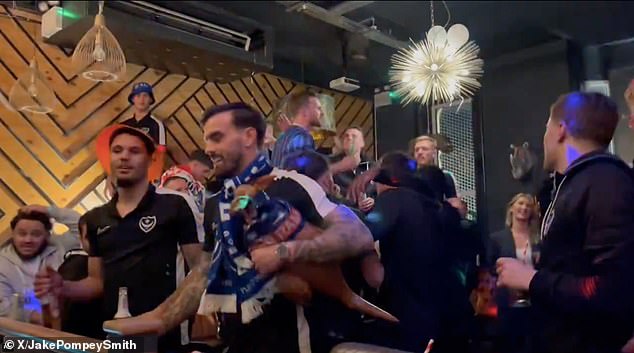 Pompey players joined fans in singing Oasis' Wonderwall after securing promotion to the Championship as League One winners.