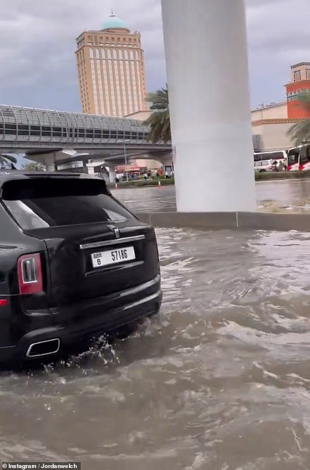 Waves begin to crash on the road as cars stall in Dubai