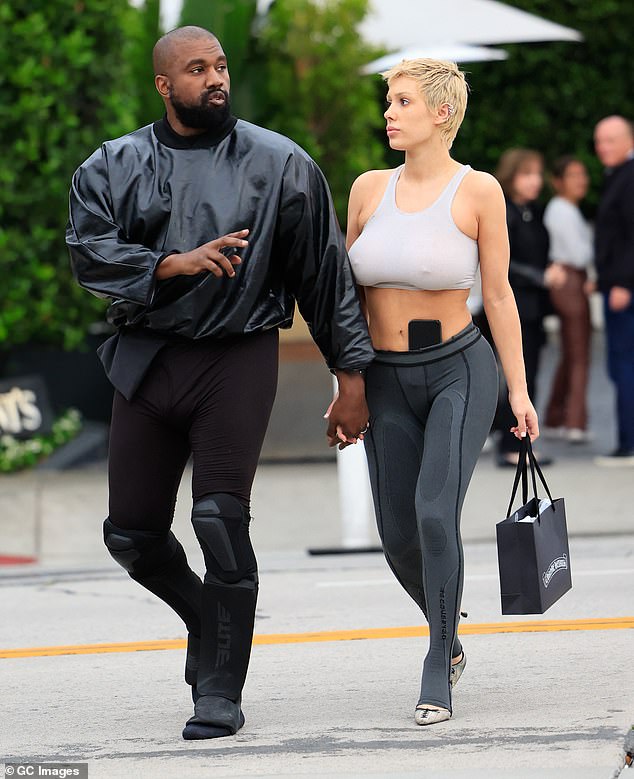 Kanye wore white clothing, unlike his usual all-black outfits.  The couple visited Star Wars Nite and took a ride on the carousel;  photographed in May 2023 in Los Angeles